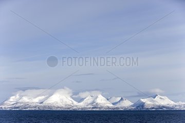 Snow-covered mountains on the coast of North Sea Norway