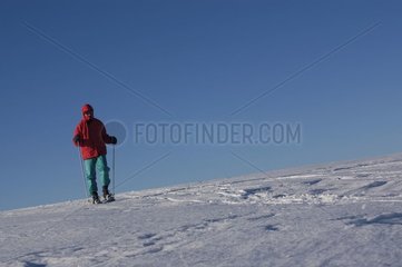 Hiker with rackets on snow Plateau de l'Aubrac France