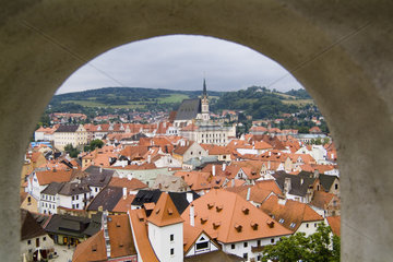 Beautiful aerial thru window from mountaintop of the picturesque small village with the red roofs of Cesky Krumlov in the Czech Republic