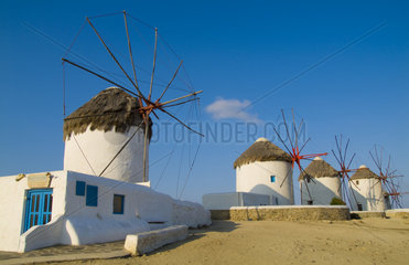 Beautiful scenic color of white famous windmills on beach of beautiful island of Mykonos Greece