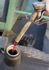 Filling up a tractor tank with diesel oil