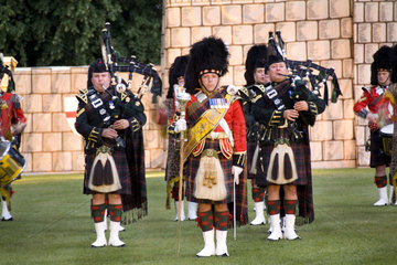 Pipes & Drums band called the Royal Scots Dragoon Guards performing at the Highland Tatoo games in quaint town of Inverness Scotland in the Highlands home of the Loch Ness Monster