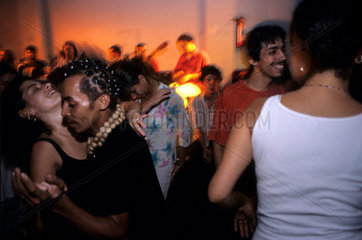 South American nightclub with young people dancing. Rio de Janeiro  Brazil. Couple in love affair  multi-ethnic people having fun  sensuality  youth. Samba party at Clube Democr__ticos ( Democraticos Club )  in Lapa. boemia  bohemianism  loose living.