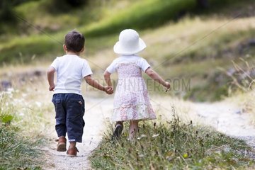Girl and boy walking hand in hand Southern Alps