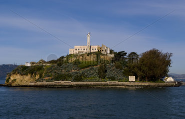 Famous landmark attraction of Alcatraz Prison on bay island in San Francisco California fron bay water approaching prison