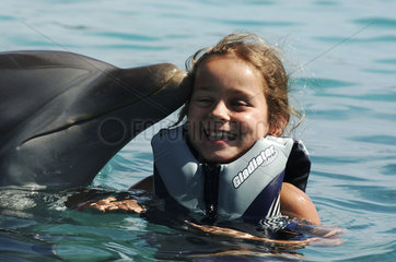 Netherlands Antilles  Curacao  a girl is kissed by a dolphin at the Dolphin academy