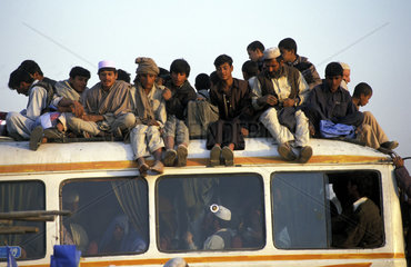 Kabul  travellers on the roof of a public bus