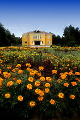 Beautiful yellow government building with flowers in Obnova Bulgaria