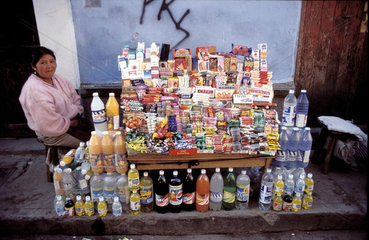 Peru  Woman selling beverages  sweets and cigarettes in the street.