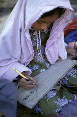 Girl writing at school  Afghanistan