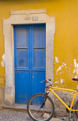 Close up of colorful wall and bike still life color abstract in small village of Tavira in Portugal Algarve coast
