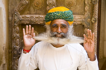 Jodhpur at Fort Mehrangarh in Rajasthan India a great image of bearded character man guard in doorway of Fort Palace in costume