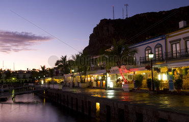 Night photographs time exposure of the beautiful harbor and restaurants of Port of Mogan Gran Canaria on coast of Canary Islands Spain