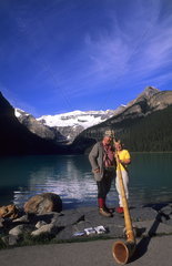 Lake Louise Banff Canada beautiful lake with Swiss Alphorn player with tourists