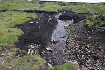 Exposed black peat soil in St. Johns Chapel Yorkshire UK