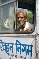 Traditional Hindu man on old bus in Jaipur Rajasthan India