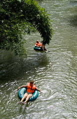 Tourists tubing on the Bells River on the North Coast of the beautiful country of Dominica in the Caribbean
