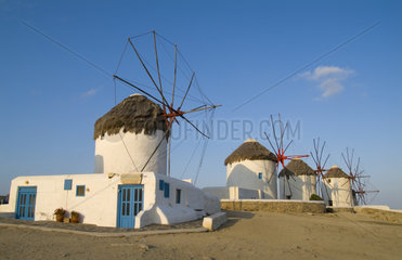 Beautiful scenic color of white famous windmills on beach of beautiful island of Mykonos Greece