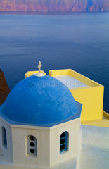Oia Santorini Greece and a beautiful church with blue roof