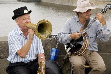 Brass polka band performing on the famous Charles Bridge of tourist city of Prague in Czech Republic