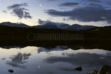 Reflections in a mountain lake at sunrise Norway