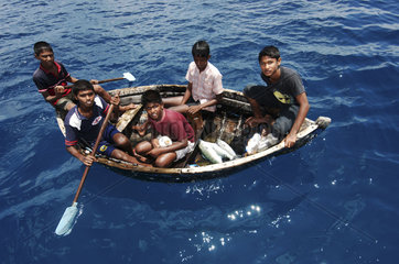 Maldives  boys catching fish in the Indian Ocean