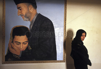 Kabul  a painting of president Hamid Karzai showing that he is taking care of womens right