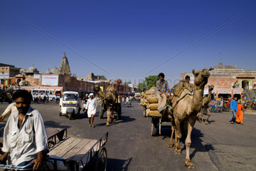 Traffic and traditional transportation in downtown center of the Pink City of Jaipur in Rajasthan India