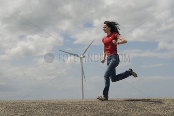 Woman running in front of a Windmill Holland