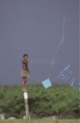 Boy playing kite Marajo island Brazil