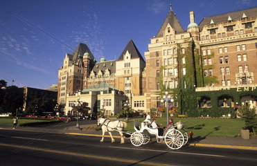 Tourist in horse drawn carriage in front of the famous Empress Hotel in beautiful Victoria British Columbia Canada