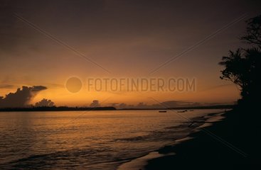 Sunset on a sand beach French Guiana