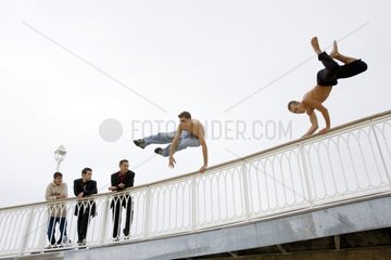 Young men jumping a guardrail France