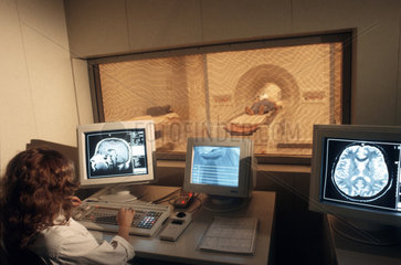 Hospital  patient being submited to medical treatment. Computer science applied to medicine. Computed tomography  the use of x-rays or ultrasound waves to produce an image  for diagnostic purposes  of a chosen section at a particular depth within the body