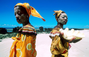 Two Macoa women in traditional dresses on the beach of Ilha Mozambique  Mozambique