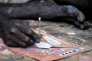 Australia Northern Territory  Darwin. Aboriginal man trys to sell his traditional art works to tourists on the street.