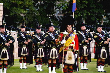Pipes & Drums band called the Royal Scots Dragoon Guards performing at the Highland Tatoo games in quaint town of Inverness Scotland in the Highlands home of the Loch Ness Monster