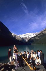 Lake Louise Banff Canada beautiful lake with Swiss Alphorn player with Japanese tourists