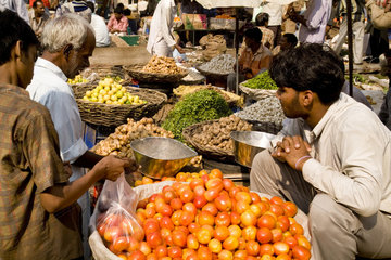 Market with locals selling fruit and vegetables in Daryagani in Old Delhi India