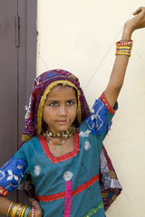 Young girl age 6 in traditional costume dancing with jewelry in Agra India