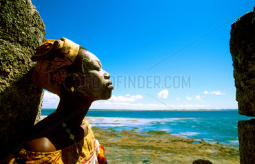 A Macoa woman rests at the end of the Island. From this point her ancestors left as slaves towards Brasil and Cuba. Ilha de Mozambique