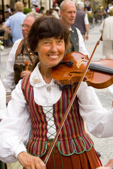 Close up of local people in traditional costume in dancing band in famous Old Town of tourist city of Prague in Czech Republic