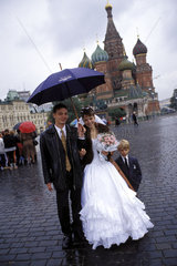 Moscow  a wedding couple at the red square to have their pictures taken in front of the st.basil__s cathedral
