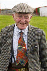 Wonderful old man age 86 at his isolated farm in Isle of Skye in Scotland dressed in wool and tie coming back from shopping for groceries