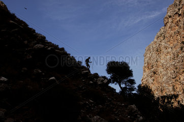 Crete  silhouette of a tourist hiking in the valley of the dead near Kato Zakros