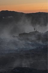 Silhouette of a photographer in the fumerolles in Iceland