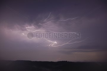 Lightning flashs crawling under a cumulonimbus France