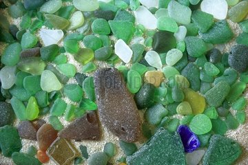 Pieces of glass polished by sand on a beach France