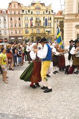 Polka dancing by local people in traditional costume with dancing band in famous Old Town of tourist city of Prague in Czech Republic