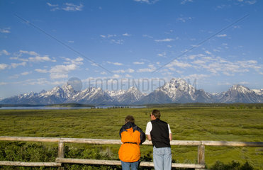 Couple enjoying the beautiful Grand Tetons mountain range near Jackson Wyoming in National Park USA